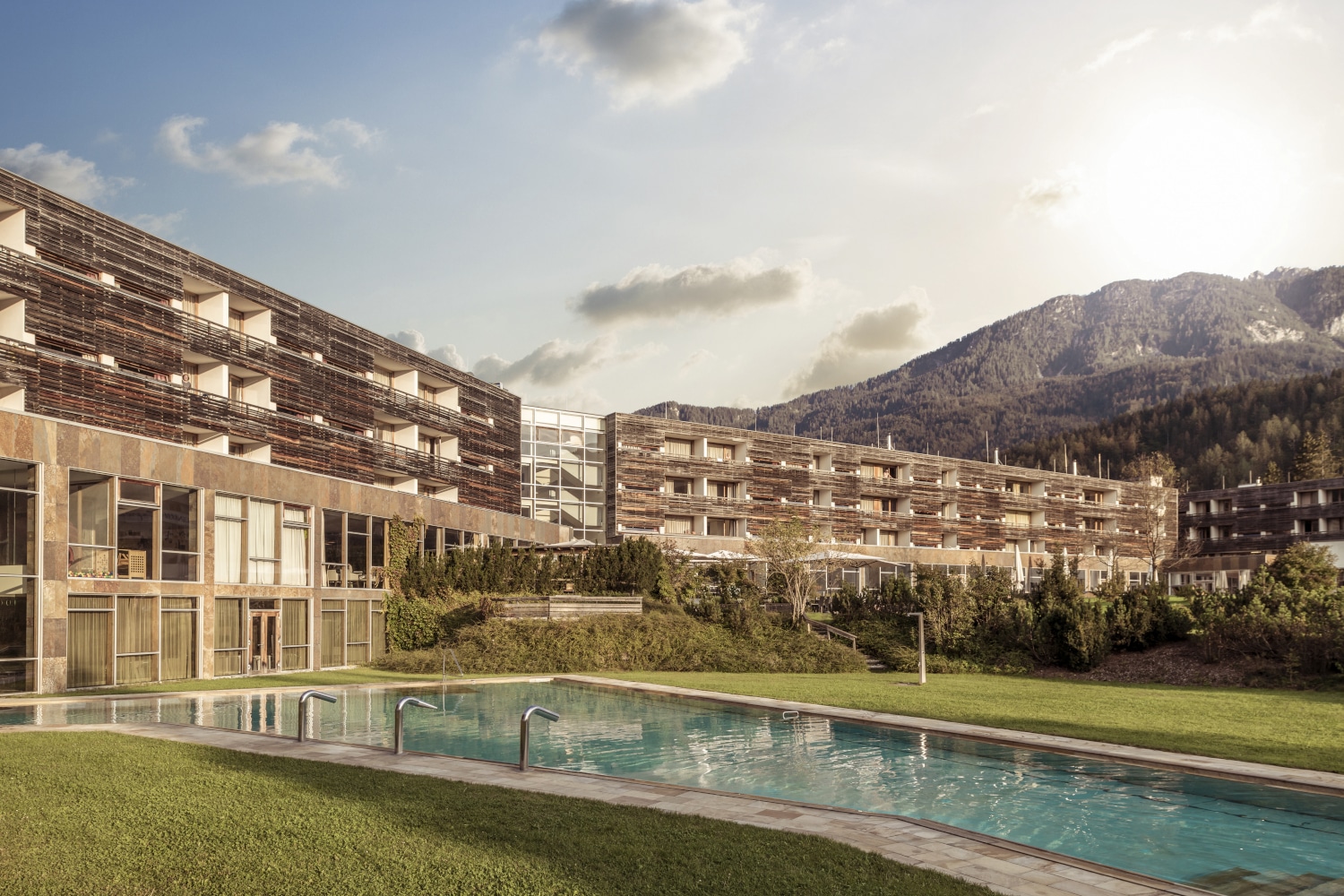 Das Falkensteiner Hotel & Spa Carinzia mit Blick vom Pool und Berge im Hintergrund